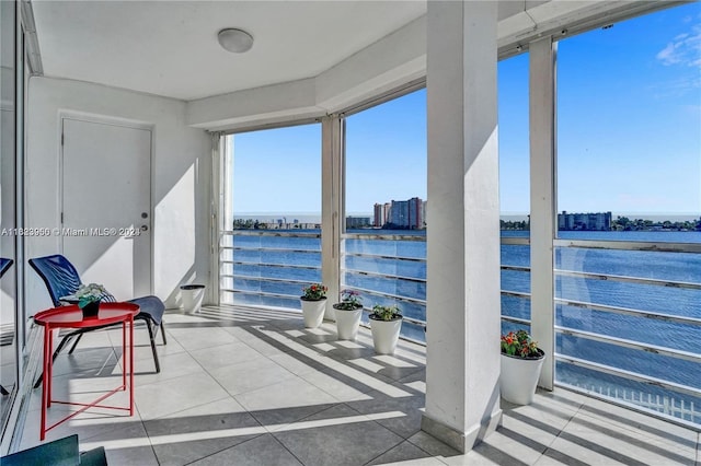 sunroom / solarium featuring a water view