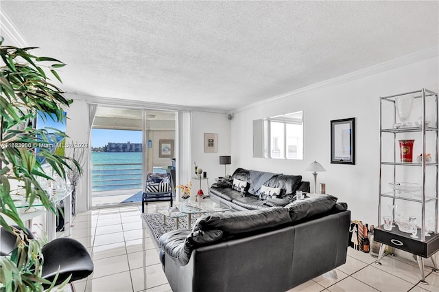 tiled living room featuring a textured ceiling, a water view, and crown molding