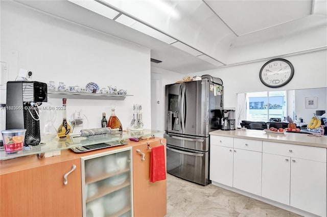 kitchen featuring white cabinets, stainless steel fridge, and wine cooler