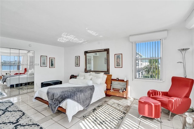 tiled bedroom featuring a water view