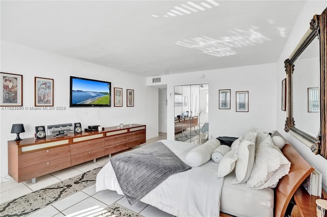 bedroom with light tile patterned floors