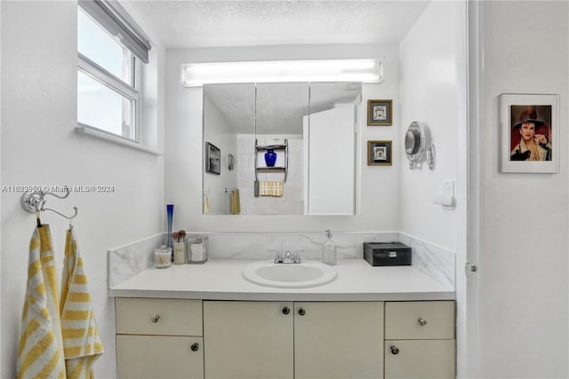 bathroom featuring vanity and a textured ceiling