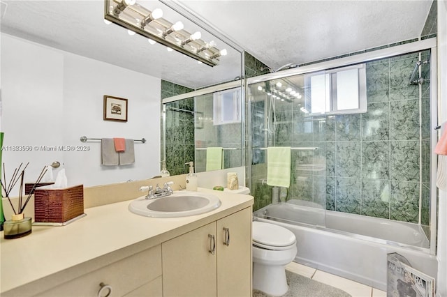 full bathroom featuring tile patterned floors, a textured ceiling, vanity, enclosed tub / shower combo, and toilet