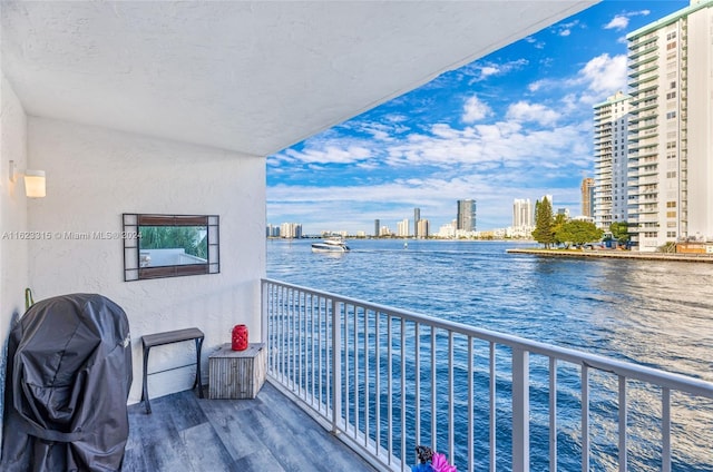 balcony featuring grilling area and a water view