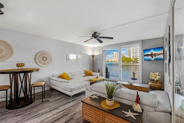 living room with wood-type flooring and ceiling fan