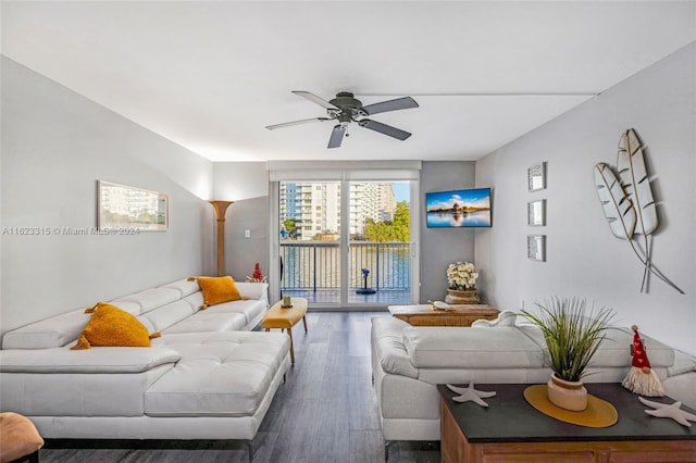 living room featuring ceiling fan and dark hardwood / wood-style flooring