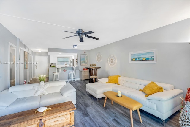 living room featuring dark hardwood / wood-style floors and ceiling fan