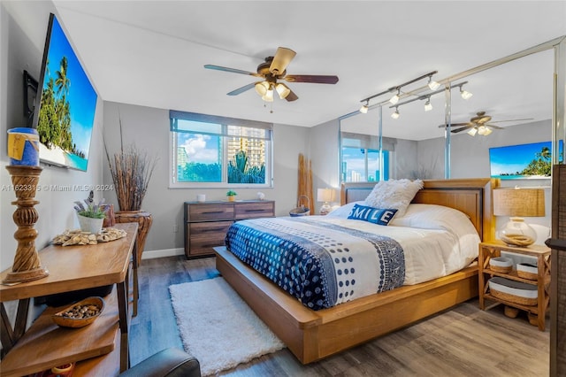 bedroom with hardwood / wood-style flooring and ceiling fan