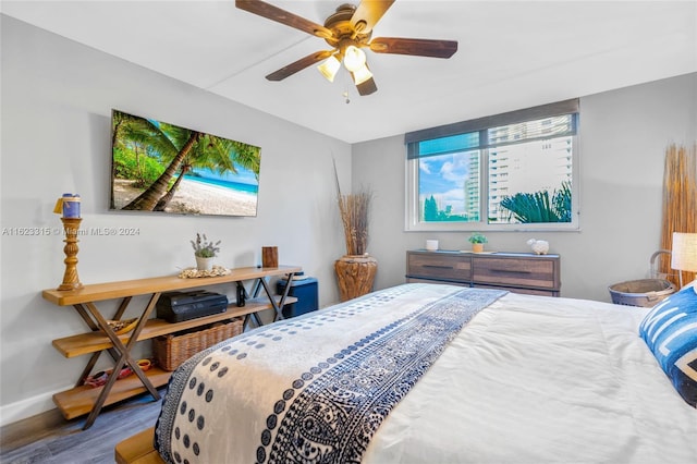 bedroom with wood-type flooring and ceiling fan