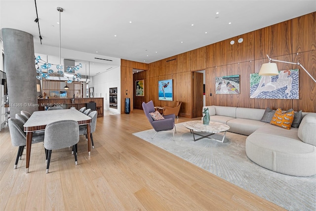 living room featuring light hardwood / wood-style flooring and wooden walls