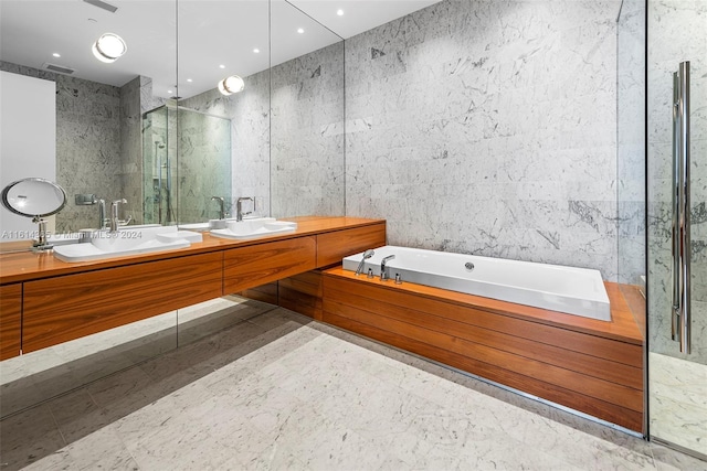 bathroom featuring tile walls, independent shower and bath, and vanity