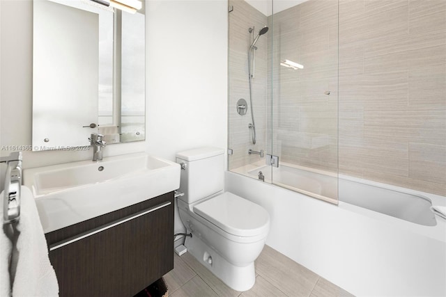 full bathroom featuring bath / shower combo with glass door, vanity, and toilet