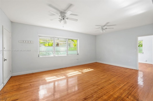 unfurnished room featuring light wood-type flooring, a wealth of natural light, and ceiling fan