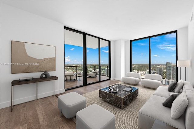 living room featuring hardwood / wood-style floors and a wall of windows