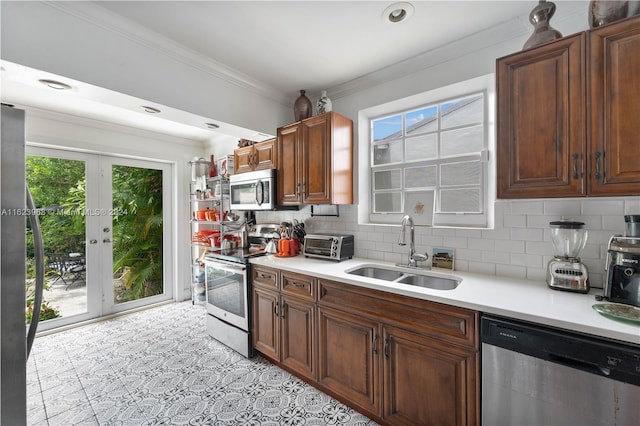 kitchen with ornamental molding and appliances with stainless steel finishes