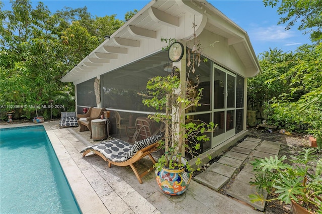 exterior space with a sunroom and a patio area