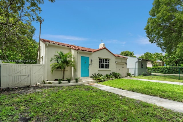 mediterranean / spanish home featuring a front yard