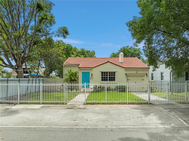 mediterranean / spanish home with a front yard