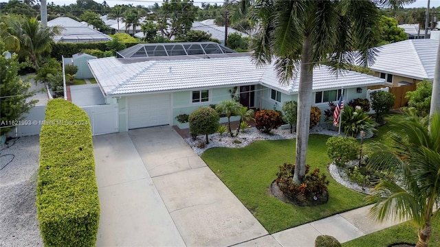 single story home featuring a garage and a front yard