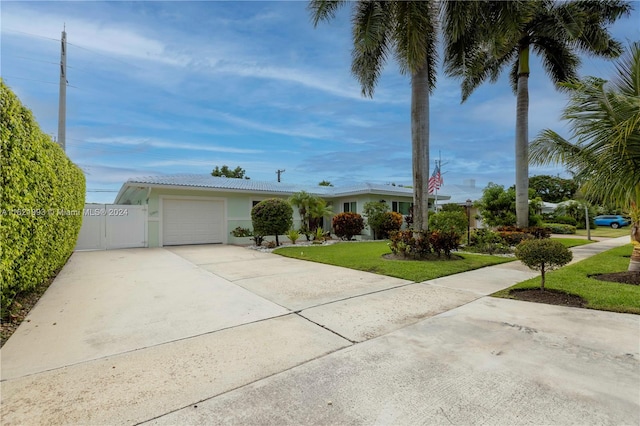 ranch-style house with a garage and a front lawn