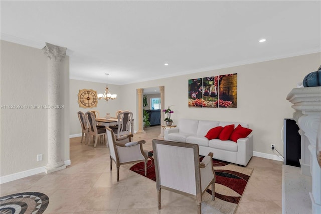 tiled living room featuring an inviting chandelier, decorative columns, and crown molding