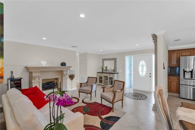 tiled living room with a fireplace and crown molding