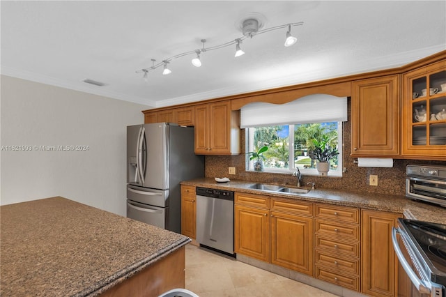 kitchen with ornamental molding, sink, decorative backsplash, and stainless steel appliances