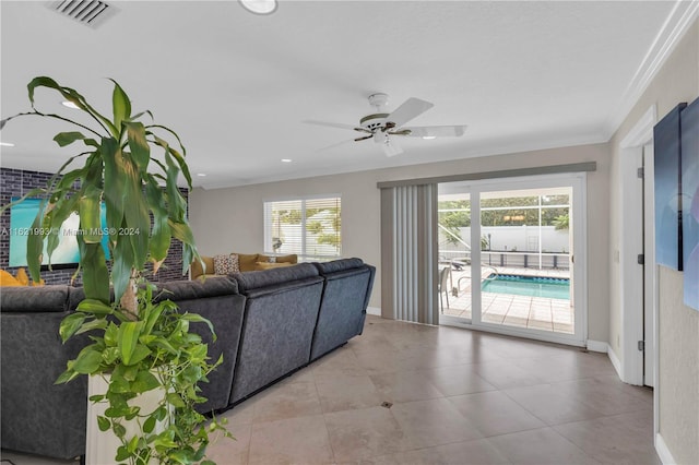 living room with light tile patterned floors, ceiling fan, and plenty of natural light