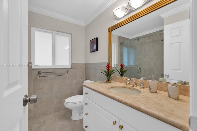 bathroom with tile patterned flooring, crown molding, toilet, vanity, and tile walls