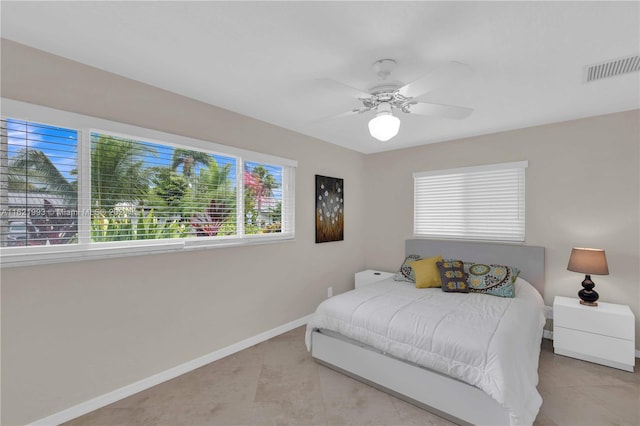 bedroom with ceiling fan and light tile patterned floors