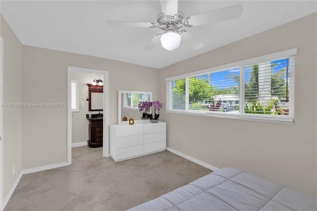 bedroom with ensuite bathroom, ceiling fan, and light tile patterned floors