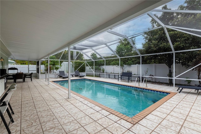 view of swimming pool with a patio and a lanai