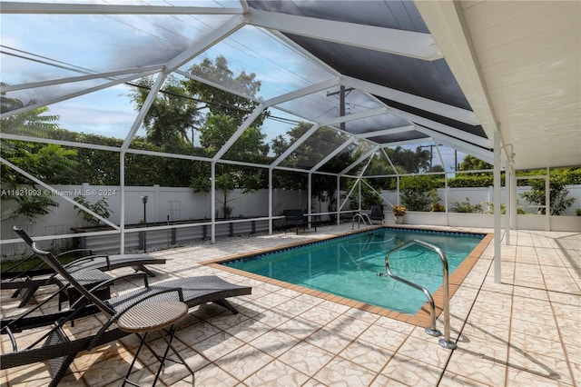 view of swimming pool featuring a patio and a lanai