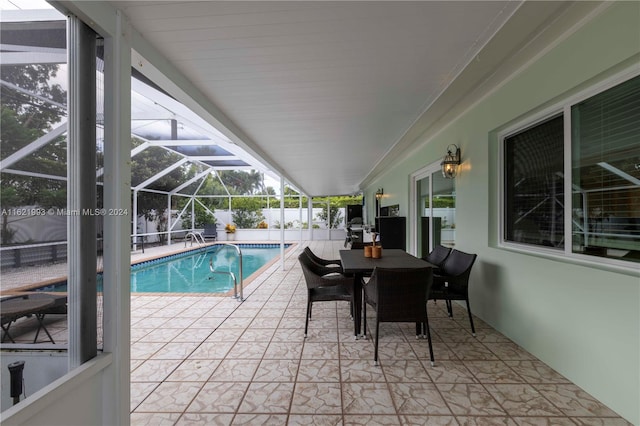 view of swimming pool with a patio and a lanai