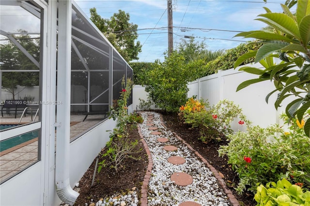 view of yard with a lanai and a fenced in pool