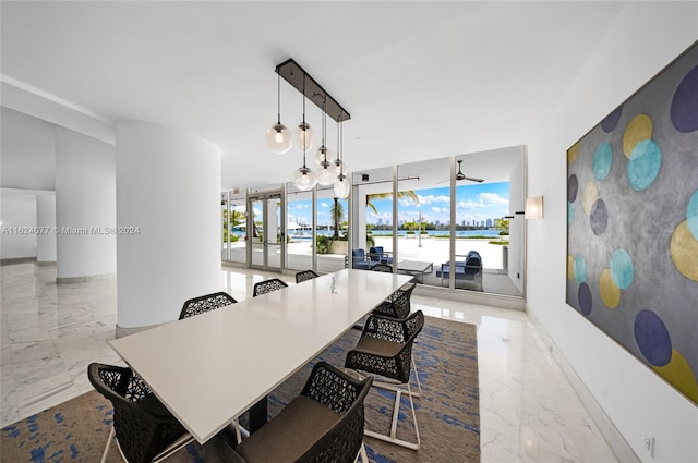 tiled dining room with a water view, expansive windows, and plenty of natural light