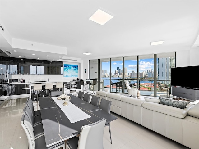 dining area featuring expansive windows and light tile patterned floors