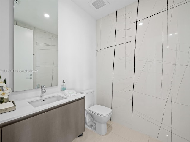 bathroom featuring tile patterned flooring, vanity, and toilet