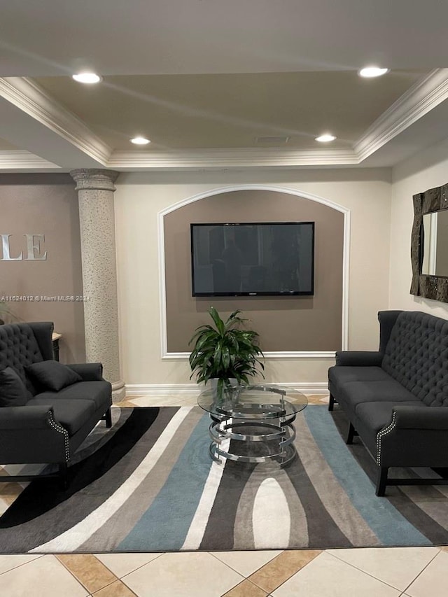 living room with tile patterned floors, crown molding, ornate columns, and a tray ceiling