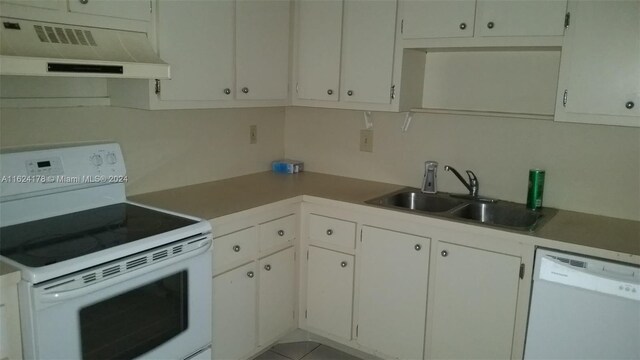901 Hillcrest Dr Unit 515, Hollywood, FL 33021 - kitchen featuring light countertops, white appliances, under cabinet range hood, white cabinetry, and a sink