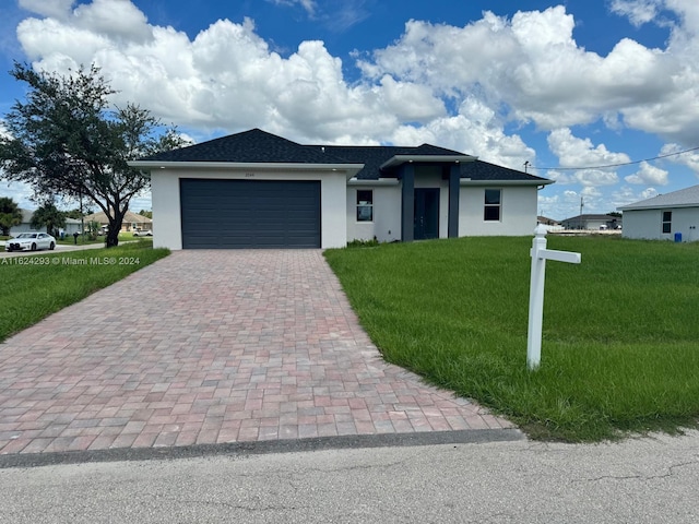 view of front of home with a garage and a front yard