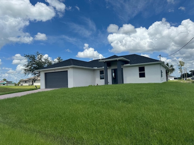 view of front of home with a garage and a front yard