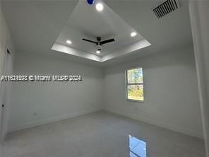 unfurnished room with a raised ceiling