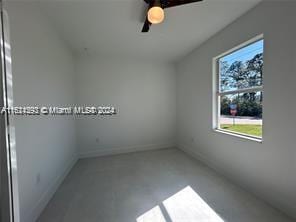 empty room with concrete flooring and ceiling fan