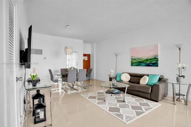 living room featuring tile patterned floors and a textured ceiling