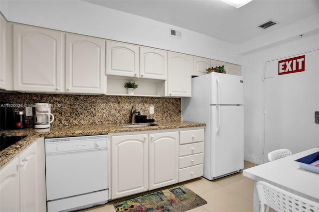 kitchen with white cabinetry, sink, white appliances, and dark stone counters