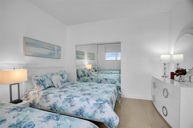 tiled bedroom featuring a closet