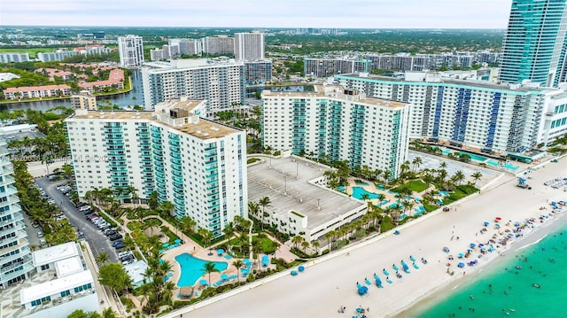 birds eye view of property with a beach view and a water view