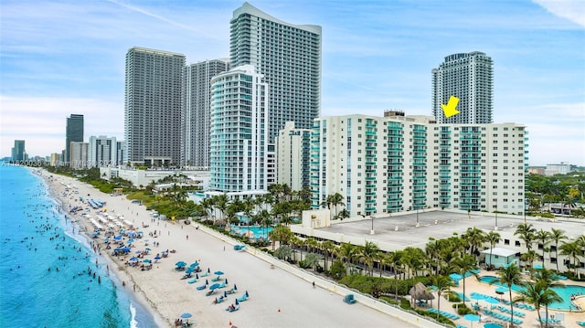 property's view of city with a water view and a beach view