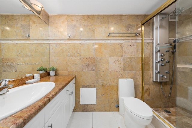 bathroom with tile patterned floors, an enclosed shower, toilet, vanity, and tile walls